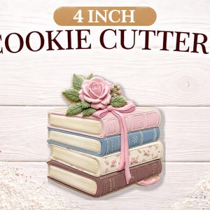 May include: A stack of 4-inch cookie cutters shaped like books, in shades of pink, blue, and brown, topped with a pink rose and green leaves. The text "4 INCH COOKIE CUTTERS" is displayed above the cutters.