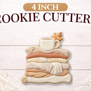 May include: A stack of cookie cutters shaped like sweaters, a coffee mug, and a fall leaf. The cookie cutters are 4 inches in size. The image has the text "4 INCH COOKIE CUTTERS" at the top.
