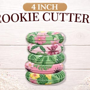 May include: A stack of five 4-inch cookie cutters with a tropical floral design. The cutters are in shades of green and pink, with images of flowers and leaves. The text "4 INCH COOKIE CUTTERS" is at the top.