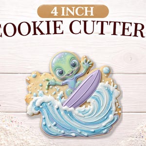 May include: A 4-inch cookie cutter shaped like an alien surfing on a wave. The cookie is decorated with blue, green, and purple icing. The text "COOKIE CUTTERS" is above the cookie.
