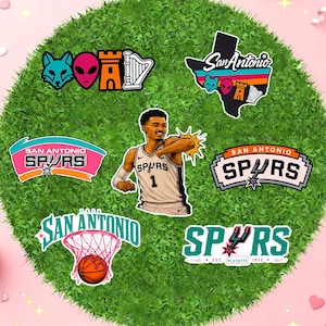 May include: A collection of San Antonio Spurs-themed stickers and graphics on a green, circular background. The stickers feature the team's logo, the city's name, and a basketball player. Colors include black, white, teal, orange, and pink.