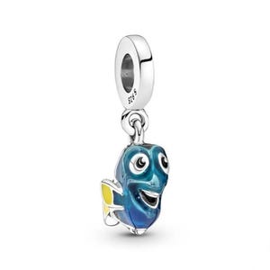 May include: A silver charm depicting a cartoon fish in shades of blue and yellow, with a cheerful expression. The charm is designed to hang from a bracelet or necklace. The fish has large eyes and is made of enamel.