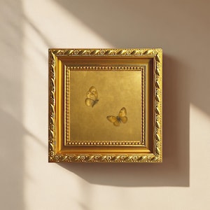 May include: A square wall art piece featuring two butterflies with golden-brown wings centered on a metallic gold background. The artwork is encased in a thick, ornate, textured gold frame with intricate decorative patterns along the edges.