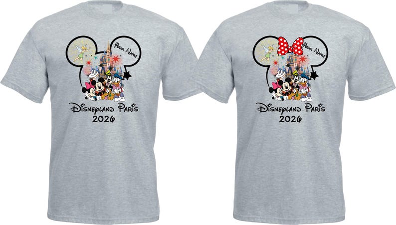 May include: Two light gray t-shirts featuring a Disney design. One shirt has a red polka dot bow on the Mickey Mouse ears, the other does not. Both shirts display Disney characters, the text "Disneyland Paris 2026", and a space for a name.