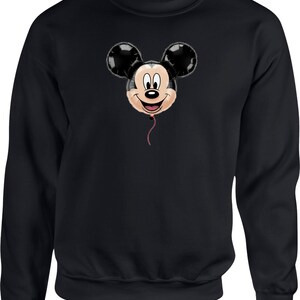 May include: Black sweatshirt featuring a Mickey Mouse balloon design. The balloon has black ears, a smiling face, and a red string. The sweatshirt is a solid black color.