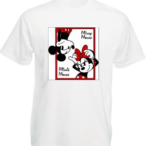 May include: White t-shirt featuring a graphic of Mickey and Minnie Mouse in a red-bordered frame. Mickey is upside down, and Minnie is upright, both smiling. The words "Mickey Mouse" and "Minnie Mouse" are printed on the frame.