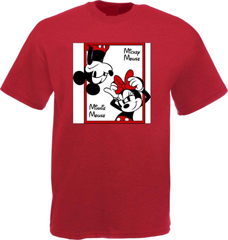 May include: Red t-shirt featuring a graphic of Mickey and Minnie Mouse. The design includes the text "Mickey Mouse" and "Minnie Mouse" in black font. Mickey is upside down, and Minnie is smiling with a red bow.
