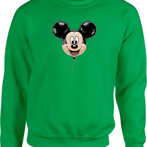 May include: A green sweatshirt featuring a Mickey Mouse balloon design. The balloon has black ears, a beige face, and a red string. The sweatshirt is a solid green color.