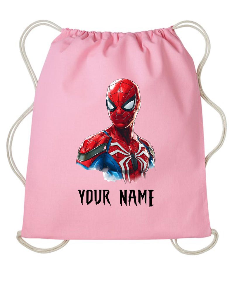 May include: A pink drawstring backpack featuring a detailed illustration of Spider-Man. The superhero is depicted in his classic red and blue suit. The text "YOUR NAME" is printed in black below the image.