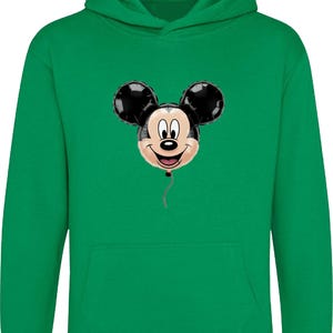 May include: Green hooded sweatshirt featuring a Mickey Mouse balloon graphic. The balloon has black ears and a smiling face. The sweatshirt has a kangaroo pocket and a drawstring hood. A fun and colorful design for fans of the iconic character.