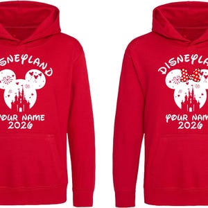 May include: A white ceramic mug with a black handle and the text "But First, Coffee" in a bold, black font. The mug is set against a neutral background, highlighting its simple design.