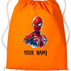 May include: Orange drawstring bag featuring a Spiderman graphic. The superhero is depicted in red, blue, and white, with the text "YOUR NAME" in black below the image. The bag has white drawstrings.