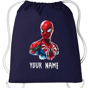 May include: Navy blue drawstring backpack featuring a Spiderman graphic. The superhero is depicted in red, blue, and white, with the text "YOUR NAME" in white below the image. The bag has white drawstrings.