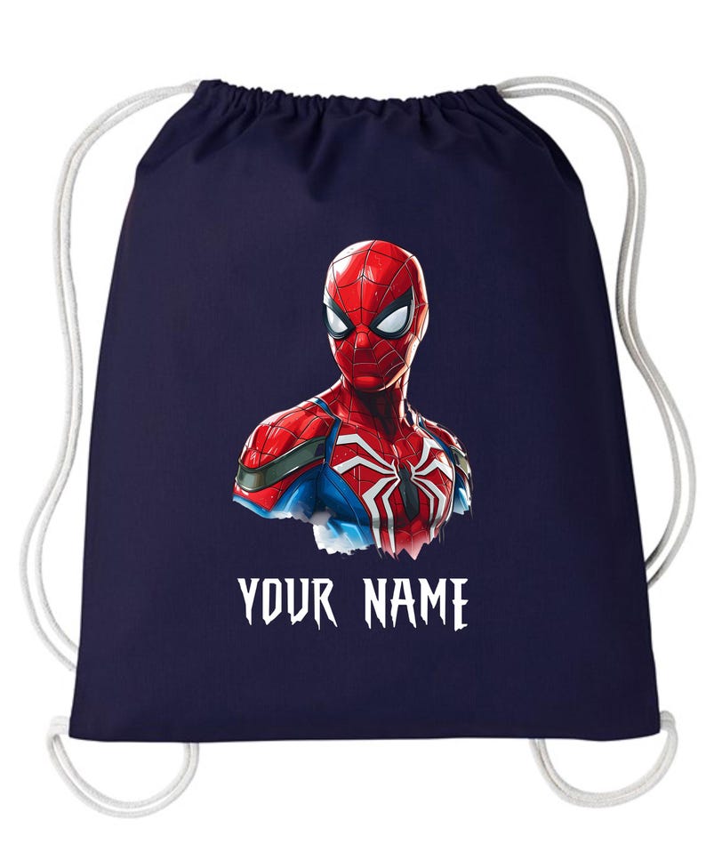 May include: Navy blue drawstring backpack featuring a Spiderman graphic. The superhero is depicted in red, blue, and white, with the text "YOUR NAME" in white below the image. The bag has white drawstrings.