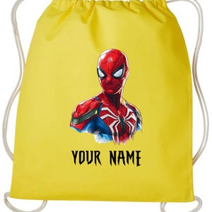 May include: Yellow drawstring backpack featuring a graphic of Spider-Man. The superhero is depicted in red, blue, and white, with the text "YOUR NAME" in black below the image. The bag has white drawstrings.