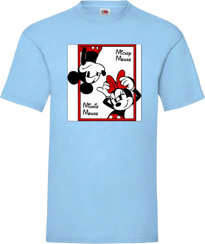 May include: Light blue t-shirt featuring a graphic of Mickey and Minnie Mouse. The design includes Mickey Mouse upside down and Minnie Mouse with a red bow. The words "Mickey Mouse" and "Minnie Mouse" are also in the design.