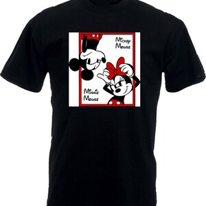 May include: Black t-shirt featuring a red-framed graphic of Mickey and Minnie Mouse. Mickey is upside down, and Minnie is upright, both in their classic cartoon styles. The words "Mickey Mouse" and "Minnie Mouse" are printed on the graphic.