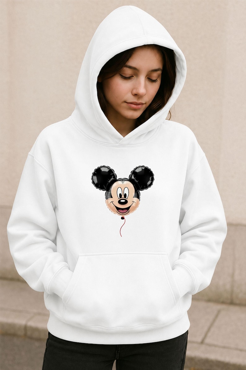 May include: White hooded sweatshirt featuring a Mickey Mouse balloon graphic. The graphic shows Mickey's face and ears in black, with a red string. The sweatshirt has a front pocket and a drawstring hood.