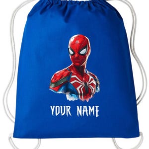 May include: A royal blue drawstring bag featuring a vibrant illustration of Spider-Man. The superhero's head and shoulders are depicted in red, blue, and white, with the text "YOUR NAME" in white below the image. White drawstring cords complete the design.