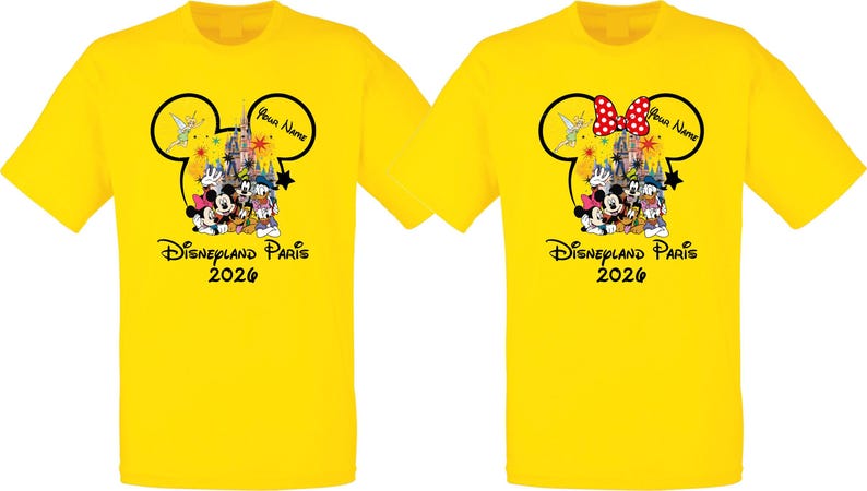 May include: Two yellow t-shirts featuring a Disney theme. Each shirt has a Mickey Mouse head outline with a castle, characters, and the text "Disneyland Paris 2026". One shirt has a red and white polka dot bow.