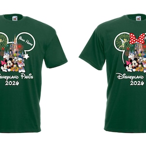 May include: Two dark green t-shirts with a Disneyland Paris 2026 graphic. One shirt features a Minnie Mouse bow and the other has a Tinkerbell design. Both shirts have a Mickey Mouse ear outline.