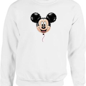 May include: White sweatshirt featuring a Mickey Mouse balloon design. The balloon has black ears and a smiling face with a red string. The sweatshirt is a solid white color.
