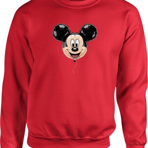 May include: A red sweatshirt featuring a Mickey Mouse balloon design. The balloon has black ears and a smiling face. The sweatshirt is a solid red color, with a crew neck and long sleeves.