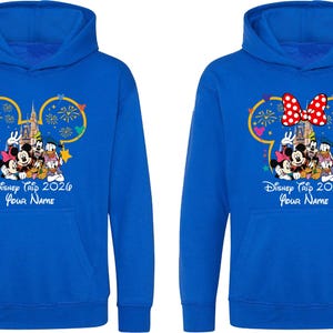 May include: Two royal blue hooded sweatshirts featuring a graphic of Mickey Mouse, Minnie Mouse, Donald Duck, and Goofy in front of a castle with fireworks. The text reads Disney Trip 2026 and Your Name. One hoodie includes a red and white polka dot bow.