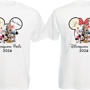 May include: Two white t-shirts with a Disneyland Paris 2026 design. One shirt features a Mickey Mouse head with Tinkerbell and a castle graphic. The other shirt has a Minnie Mouse head with a red bow and the same graphic.