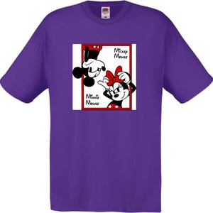 May include: A purple t-shirt featuring a graphic of Mickey and Minnie Mouse. Mickey is upside down, and Minnie is right-side up, both in a red-bordered box. The words "Mickey Mouse" and "Minnie Mouse" are also in the box.