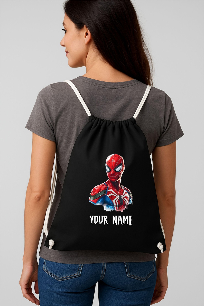 May include: Black drawstring backpack featuring a vibrant Spider-Man graphic. The superhero is depicted in red and blue, with a white spider emblem. The text "YOUR NAME" is printed in white below the image. White cords serve as straps.