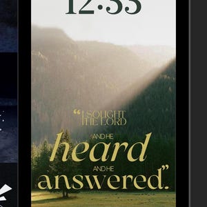 May include: A phone lock screen displays the time, date, and a scenic landscape. The text reads "I sought the Lord and He heard and answered." The word "heard" is in a large, stylized font. A "Focus" button is at the bottom.