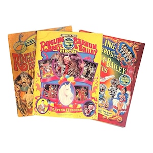 May include: Three vintage Ringling Bros. and Barnum & Bailey Circus posters. The posters feature colorful illustrations of circus performers, animals, and the text "The Greatest Show on Earth." One poster highlights a "Living Unicorn."