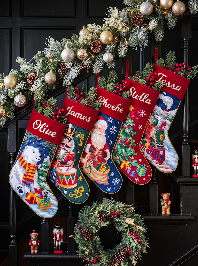 May include: Five personalized Christmas stockings featuring embroidered names Olive, James, Phoebe, Stella, and Tessa. The stockings display festive needlepoint designs including a polar bear, nutcracker, Santa Claus, Christmas tree, and a steam train.