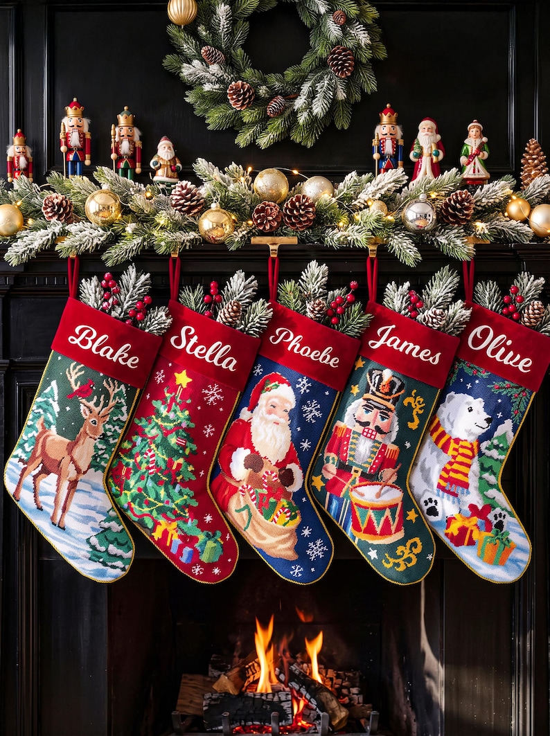 May include: Five Christmas stockings with red cuffs featuring the names Blake, Stella, Phoebe, James, and Olive. The stockings display festive needlepoint designs including a reindeer, a Christmas tree, Santa Claus, a nutcracker, and a polar bear.