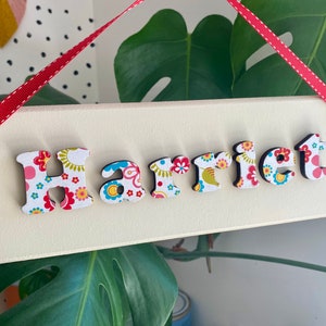 Children's personalised wooden bedroom door sign / name plaque in a multicoloured floral design