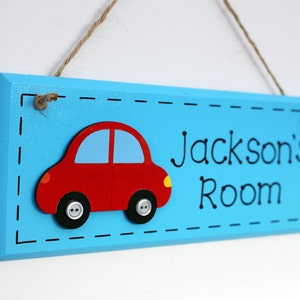 Blue wooden bedroom door sign with car