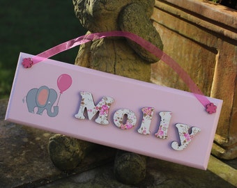 Pink wooden bedroom door sign with baby elephant illustration