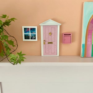 Miniature wooden pink fairy opening door, with window and working mail box