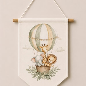 May include: A cream-colored fabric wall hanging featuring a watercolor illustration of a hot air balloon with green and beige stripes. Inside the basket are a gray elephant, a yellow giraffe, and a brown lion. Green leaves surround the base. Code: 5.