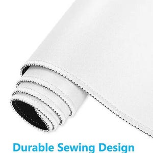 May include: Rolled-up white mouse pad with a black stitched edge. The mouse pad has a smooth surface and the text "Durable Sewing Design" in blue.