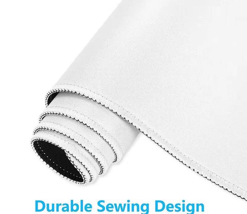 May include: Rolled-up white mouse pad with a black stitched edge. The mouse pad has a smooth surface and the text "Durable Sewing Design" in blue.