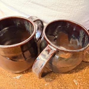 Une paire de mugs ocres. Poterie faite main