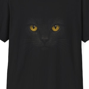 Glowing Black Cat Eyes Unisex T-Shirt - Mystical Yellow-Eyed Feline in the Dark, Gift for Cat Lovers & Halloween