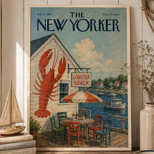 May include: A framed print of a July 6, 1963 New Yorker magazine cover featuring a white building with a large red lobster illustration, a sign reading LOBSTER SHACK, a patio with a striped umbrella, chairs, and a harbor view with boats.