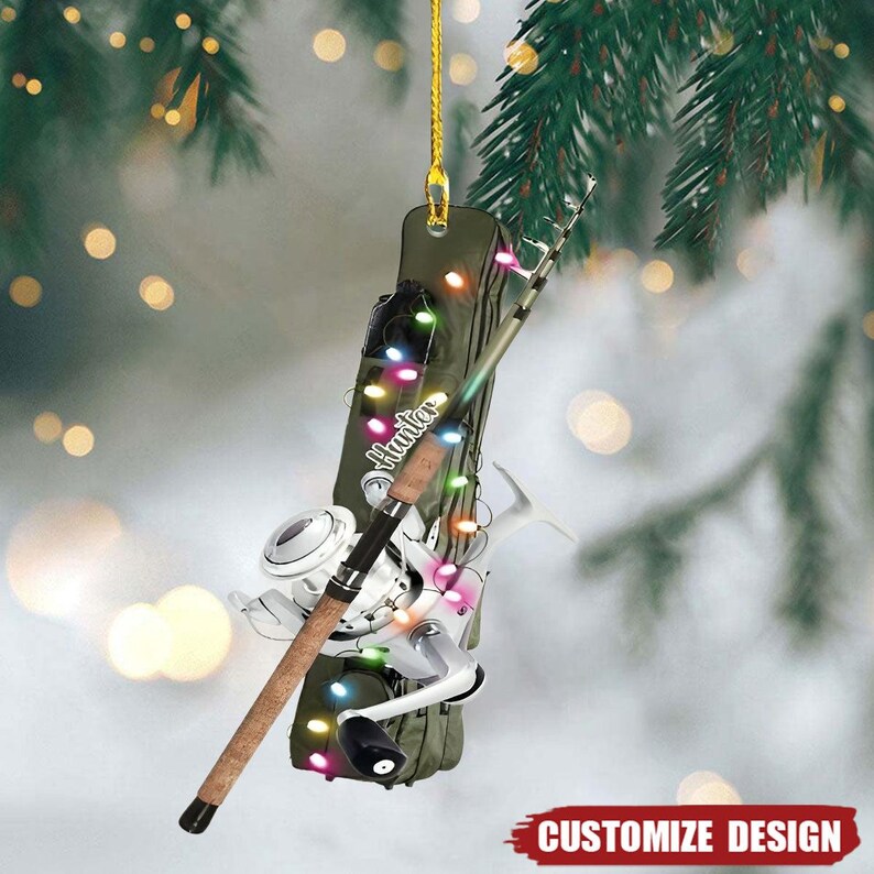 May include: A fishing-themed Christmas ornament with a fishing rod, reel, and a green case with the word "Hunter". The ornament is decorated with colourful lights and a gold string for hanging. The words "Customize Design" are at the bottom.