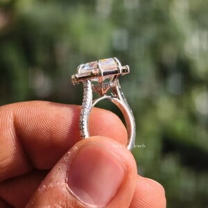 This detailed side profile shot reveals the intricate hidden halo tucked beneath the Dutch marquise center stone. The 6-prong basket provides a secure lift, while the hidden accents add a touch of "Secret Sparkle" visible only from this angle. The high-polish finish of the solid gold band transitions seamlessly into the pave shank, illustrating the meticulous metalwork and structural integrity of NovaLux Jewels.