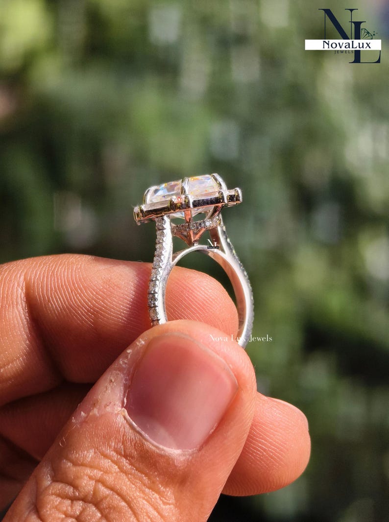 This detailed side profile shot reveals the intricate hidden halo tucked beneath the Dutch marquise center stone. The 6-prong basket provides a secure lift, while the hidden accents add a touch of "Secret Sparkle" visible only from this angle. The high-polish finish of the solid gold band transitions seamlessly into the pave shank, illustrating the meticulous metalwork and structural integrity of NovaLux Jewels.