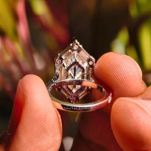 A perfectly centered top-down shot of the Dutch marquise ring, emphasizing its geometric symmetry and balanced proportions. The 6-prong setting remains clean and understated, allowing the large surface area of the unique cut to remain the focal point. This angle highlights the modern Art Deco influence and the architectural silhouette favored by modern jewelry lovers in 2026.