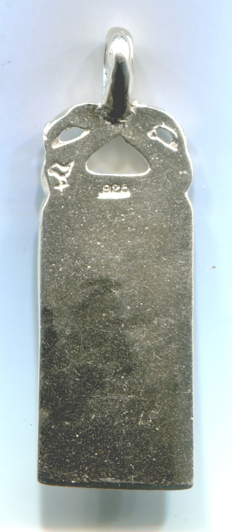 May include: Silver pendant with a detailed design and a 925 stamp on the back.